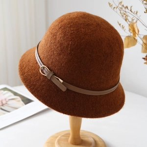 Detailed close-up of brown wool cloche hat with leather belt and gold buckle on a stand