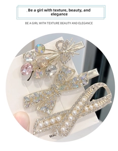 Close-up of three Korean style hair clips featuring rhinestones, crystals, and pearls