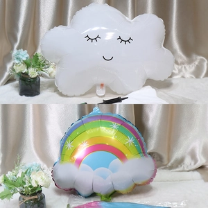 Detail of white smiling cloud and rainbow tassel foil balloons for birthday decoration