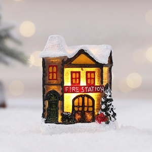 Miniature Christmas fire station house with LED lights and snow roof decoration
