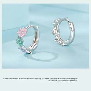Close-up of S925 sterling silver hoop earrings featuring colorful enamel flower charms
