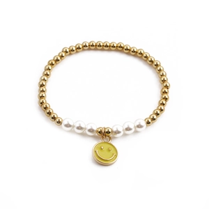 Gold beaded bracelet with white pearls and a yellow enamel smiley face charm on white back