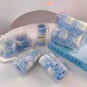 Detail of high-elasticity hair ties in sea salt blue and cream with cute pattern cubes