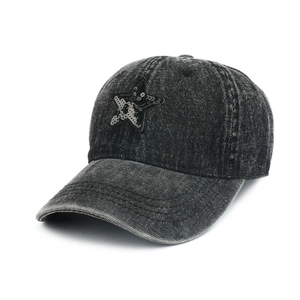 Detail of sequin star patch on washed denim baseball cap with vintage distressed texture