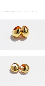 Macro detail of polished 24k gold plated oval hoop earrings showing the glossy mirror finish