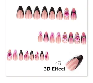 Détail d'ongles amande noir français avec dégradé rose et fleurs en relief 3D