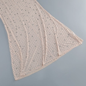 Detail of nude mesh fabric featuring shimmering silver rhinestones and crystal beadwork