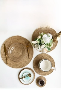 Detailed view of hand-woven jute placemats with spiral texture in various sizes