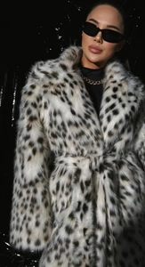 Close-up of leopard print faux fur coat with plush texture and belted waist detail