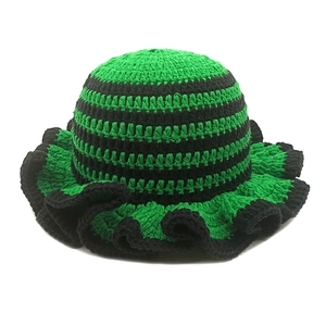 Handmade crochet ruffle hat with green and black horizontal stripes in wavy brim design