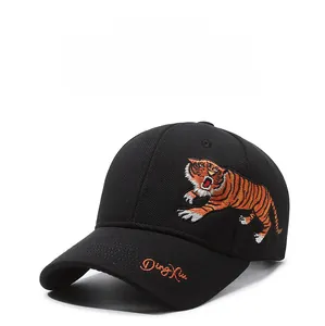 Detailed close-up of tiger embroidery on a black cotton baseball cap with curved brim
