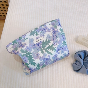 Macro detail of floral cotton makeup bag with purple flower print and simple wish label