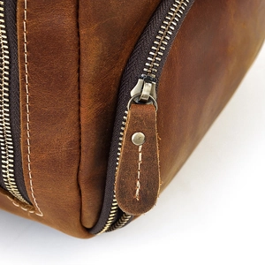 Close-up of vintage brown crazy horse leather texture with metal zipper and stitching