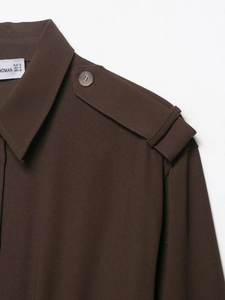 Detail of dark brown shirt with shoulder epaulette and pearlescent button detail