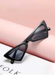 Close-up of retro black cat-eye sunglasses on a pink prop with high-quality finish