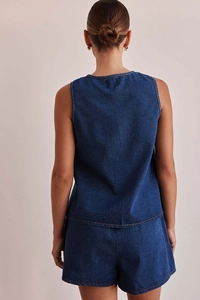 Rear view of dark blue denim two-piece set featuring sleeveless top and high-waist shorts