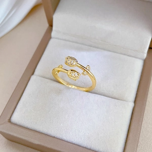 Macro shot of gold tulip ring with sparkling diamonds inside a beige jewelry box