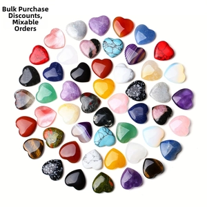Flat lay of colorful 2cm heart-shaped natural stones in a circular arrangement
