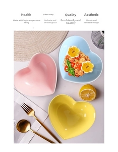 Macro view of heart-shaped ceramic dessert plates in pastel pink blue and yellow colors