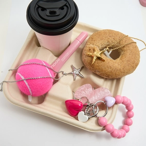 Flat lay showing gold and silver starfish necklaces with a pink beaded heart charm