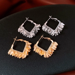 Macro detail of 18K gold and silver leaf pendants with realistic leaf vein textures