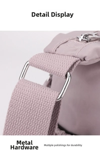 Detail of pink nylon crossbody bag showing durable silver D-ring and neat stitching