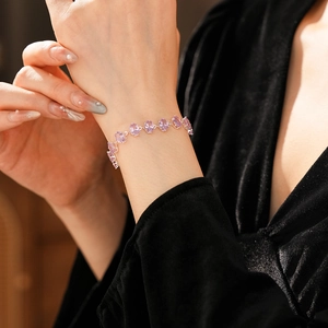 Detailed view of an oval purple zircon bracelet featuring sparkling gemstones on model wrist