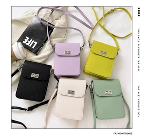 Detailed view of mini crossbody phone bags in five pastel colors on white fabric