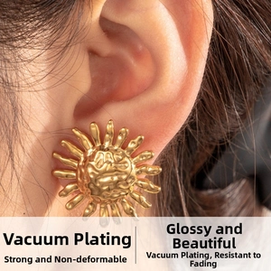 Detail of gold sunflower earrings with vacuum plating and textured metallic finish