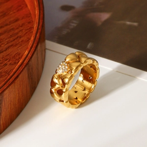 18k gold plated stainless steel heart ring with cubic zirconia on a wooden tray