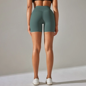Detail view of high-waist yoga shorts showing seamless stitching and butt-lifting texture