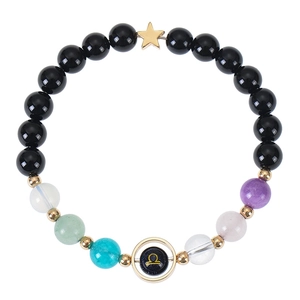 Blue goldstone zodiac bracelet with Libra symbol and golden star pendant on white background