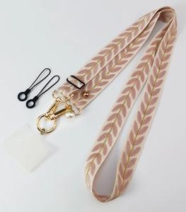 Detail view of woven pink phone lanyard with pearl pendant and gold metal hardware