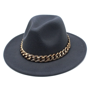Close-up of dark grey wool fedora hat featuring a bold gold metal chain decoration