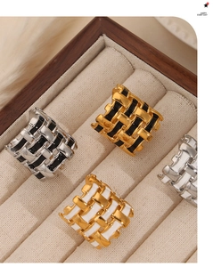 Macro detail of geometric woven titanium steel rings with colorful enamel finishes