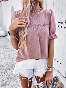 Detail of pink hollow lace top with ruffle stand collar and geometric embroidery design