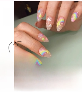 Detail of almond press-on nails with rainbow, cloud and floral macaron nail art