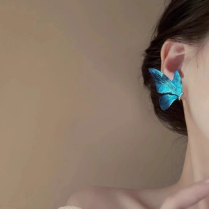 Elegant blue gradient butterfly earrings with sparkling cubic zirconia on female model