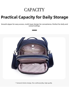 Detailed interior view of multi-compartment navy oxford bag with durable silver zippers
