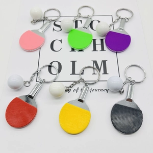 Miniature table tennis paddle keychains in multiple colors with white ping pong balls