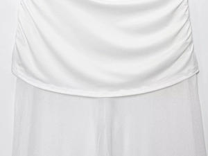 Detail of white mesh patchwork and ruched fabric texture on a one-shoulder women's outfit