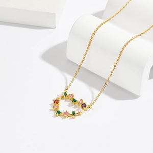 18K gold plated necklace with heart pendant, colored zircon stones and pearls on white stand