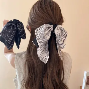 Elegant large paisley bow hair claw clips in black and white for women's hairstyles