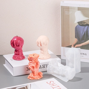 DIY silicone molds showing finished skull hand rose and sphere candles in artistic setting