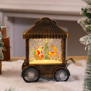 Macro shot of retro bronze Christmas cart snow globe with Santa Claus and reindeer detail