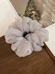 Macro shot of layered grey-purple organza fabric and soft texture of a large scrunchie