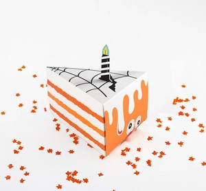 Detail of triangle cake-shaped Halloween gift box with spider web and candle decor