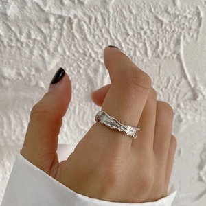Minimalist S925 sterling silver ring with irregular lava texture worn on finger