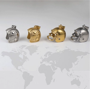 Macro shot of 24K gold and silver football helmet pendants with star embossed patterns
