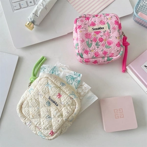 Quilted cotton storage pouches featuring floral prints and bow designs for feminine hygiene